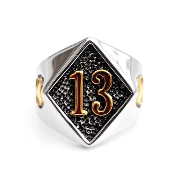A silver and gold Lucky 13 Gold Skull Ring with the number 13 on it, from Rebel Saint Co.