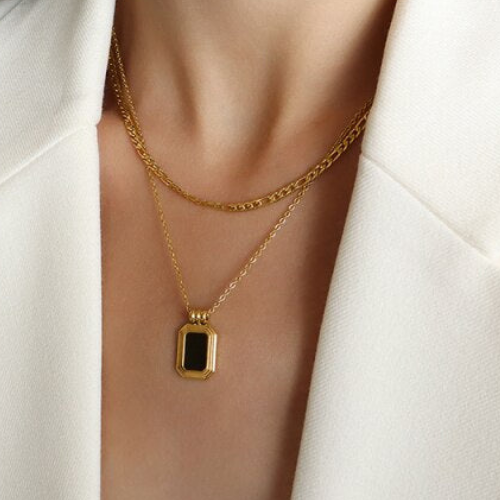A Rebel Saint Co gold necklace with a Black Stone Double stacking pendant.