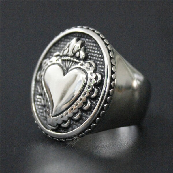 A Sacred Heart Ring by Rebel Saint Co with a heart on it.