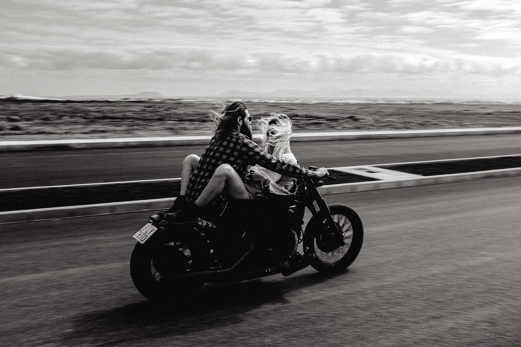 Rebel Saint Co Lifestyle: Romantic couple on a motorcycle embodying rugged elegance and rebellious spirit