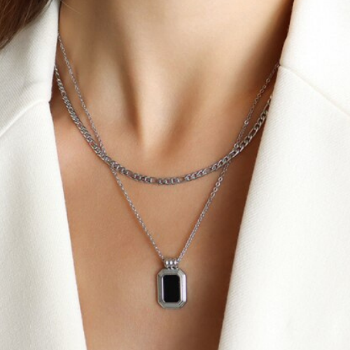 A Rebel Saint Co gold necklace with a Black Stone Double stacking pendant.